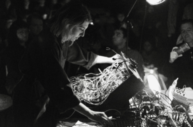 Black and white photo of Haffar using a synth