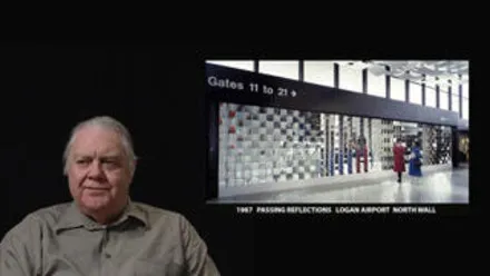 James Seawright in front of black background. Superimposed image of an airport on the right side of the screen.